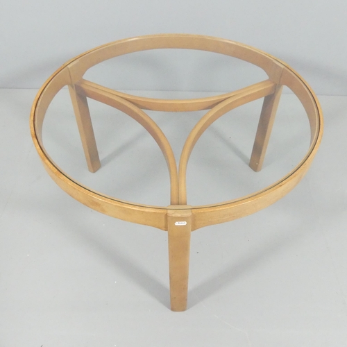 2015 - NATHAN FURNITURE - A mid-century teak circular glass-top Trinity coffee table with three oval nestin... 