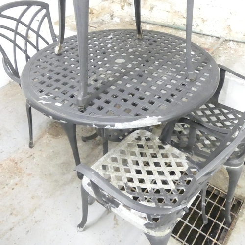 2685 - A painted metal circular garden table, 90xx72cm, and four matching chairs.