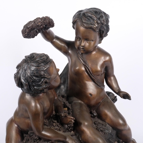 11 - A patinated spelter group of 2 cherubs, on a shaped marble base, H50cm