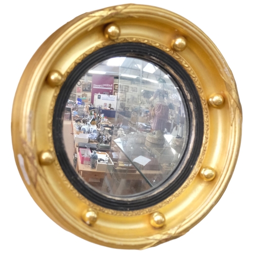 122 - An Antique miniature giltwood convex wall mirror, with ball mounts, diameter 20cm