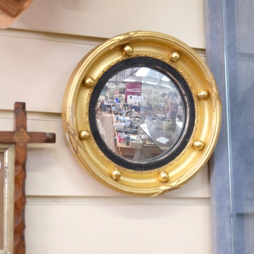 122 - An Antique miniature giltwood convex wall mirror, with ball mounts, diameter 20cm