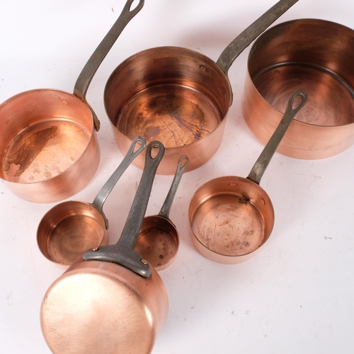 134 - A graduated set of 7 French copper saucepans with iron handles
