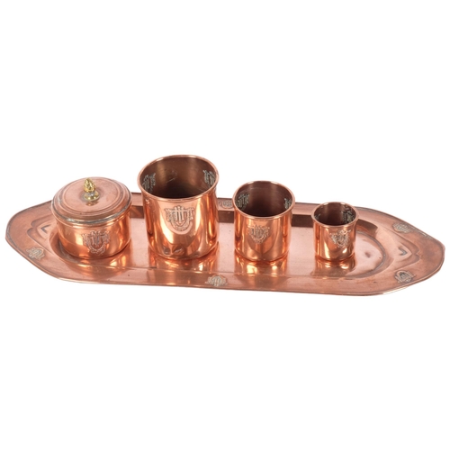136 - A French Art Nouveau copper tray of rectangular form, a graduated set of 3 matching beakers, and a l... 