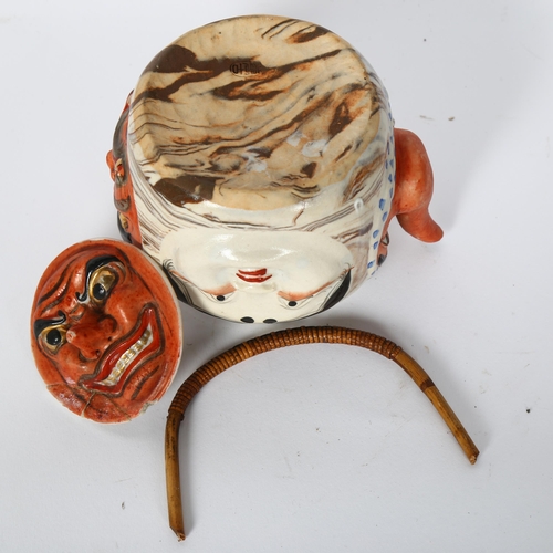 179 - A Japanese pottery hannya teapot, with woven bamboo handle, 11cm, impressed mark to the underside
