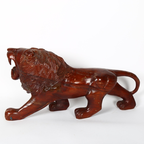 181 - A large carved hardwood study of a lion, L60cm