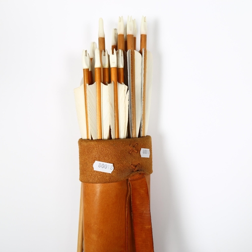 204 - A vegetable tanned leather quiver, with arm guards and finger guards, with 20 wooden arrows, all bul... 