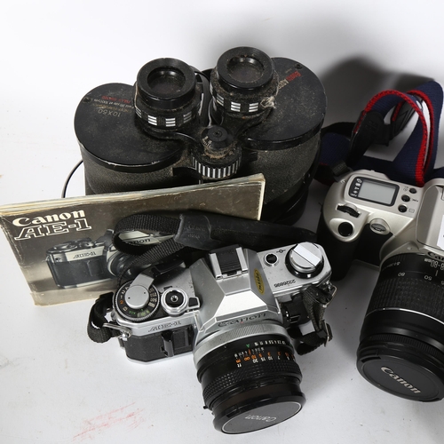 234 - A Canon AE-1 associated Canon 50mm lens, a Canon EOS500N, and associated Canon zoom lens EF28-80mm, ... 