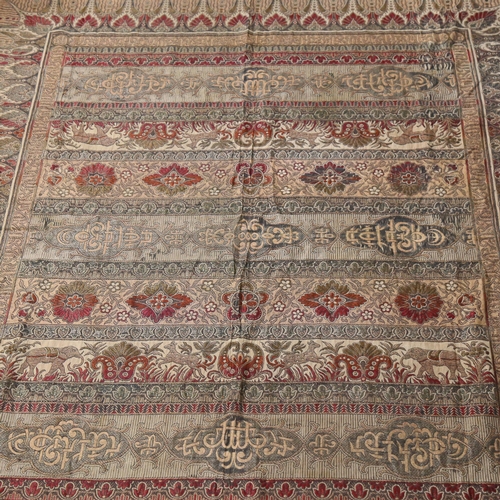 278 - An Indian needlework throw, tasselled edge, with floral and animal decoration running through the ce... 