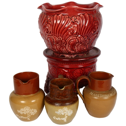 345 - Embossed pottery jardiniere on stand, H37cm overall, and 3 Vintage Cadbury's Drinking Chocolate jugs