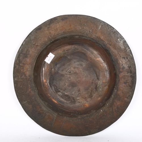 366 - An Arts and Crafts hand chased and beaten bronze dish, 26cm