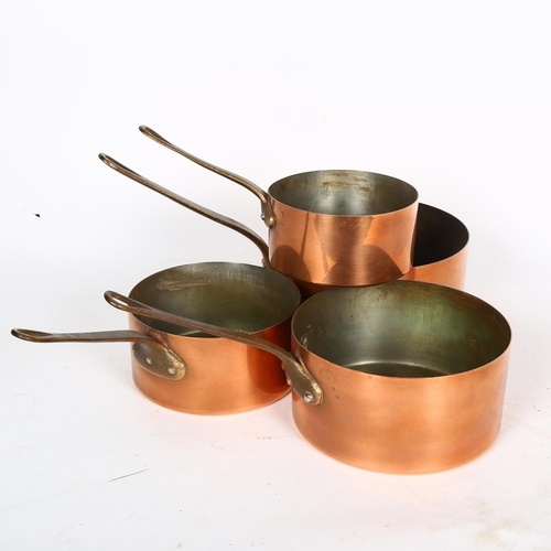 408 - A graduated set of 4 Vintage copper saucepans, with brass handles, largest 18cm diameter