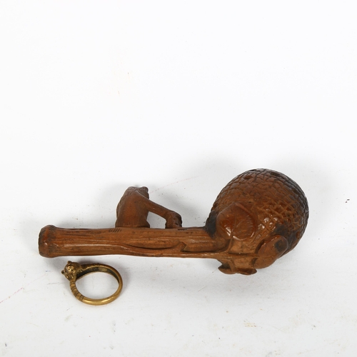 443 - A carved wood Black Forest pipe, surmounted by a bear, and a brass bear design ring (2)