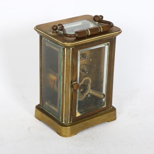 509 - A French brass-cased carriage clock with enamel dial and Roman numerals, height not including handle... 