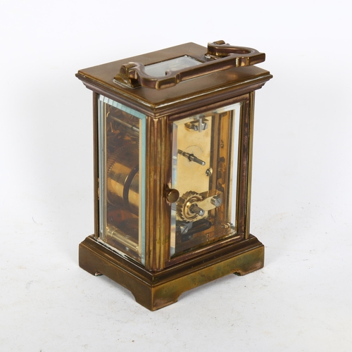 511 - An English brass-cased 8-day carriage clock, enamel dial and Roman numerals, height not including ha... 