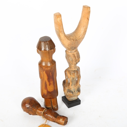 530 - A Onitshwa Province Nigeria Ibo carved figure, and another, and an African carved wood figural catap... 