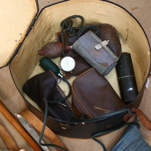 577 - A hat box, lederhosen, spectacles, blood pressure kit and a silver mounted horn handled walking stic... 