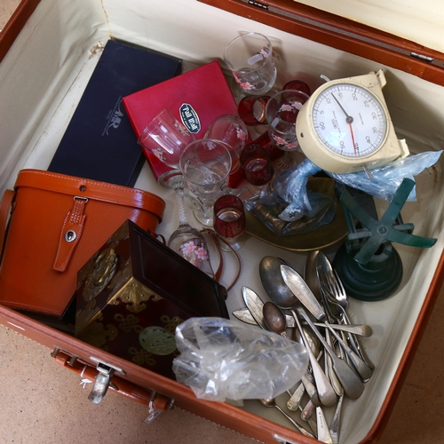 581 - A suitcase containing kitchen scale and weights, clock, binoculars, glassware and a jewellery cabine... 