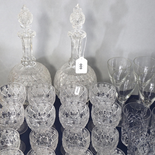 600 - A suite of Vintage cut-crystal glassware, comprising 2 decanters and stoppers, 31cm, 8 wine goblets,... 