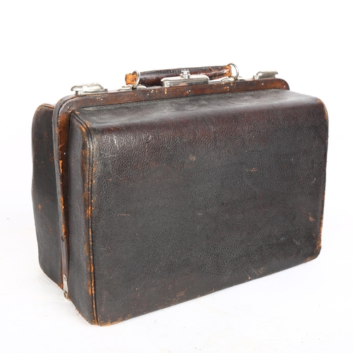 672 - Vintage leather Gladstone bag, by Mollard Bros Medical Outfitters, containing a tin of epsom salts, ... 