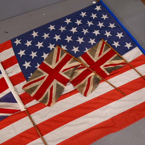 677 - 4 Vintage flags on poles, including 3 Union Jacks, and a USA machined cotton flag, 254cm  x 124cm