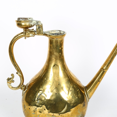 723 - A Middle Eastern brass ewer with integrated stand, H33.5cm