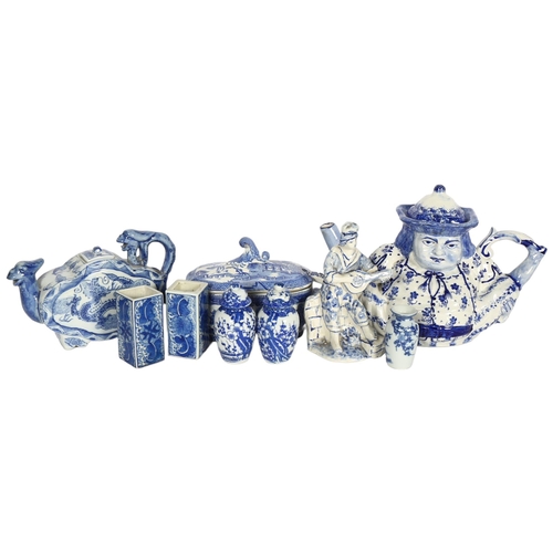 734 - A quantity of blue and white Chinese ceramic ware, including a peg leg figural Toby jug style teapot... 