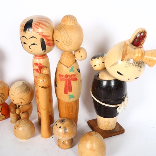 742 - A group of various Kokeshi dolls, including several mothers with children, largest height 24cm