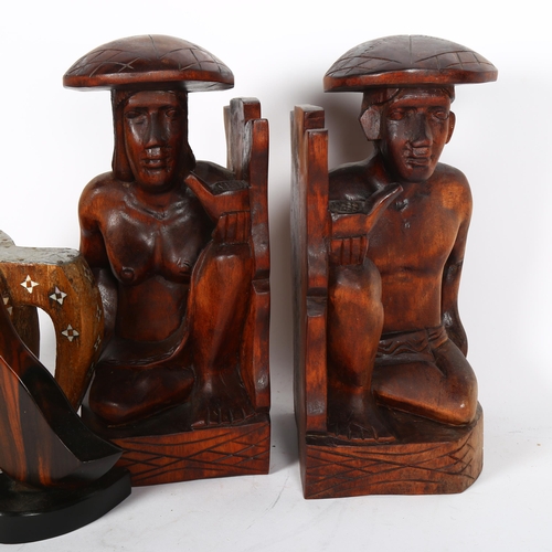 744 - A pair of bookends, Filipino carvings of a man and woman, H28cm, an Filipino Kamagon wooden duck scu... 