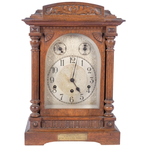 75 - A circa 1930s oak-cased mantel clock, with an engraved and embossed dial, 8-day striking movement co... 