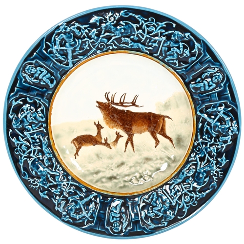 776 - An Austrian painted Majolica wall plaque, depicting stag and does, 34cm