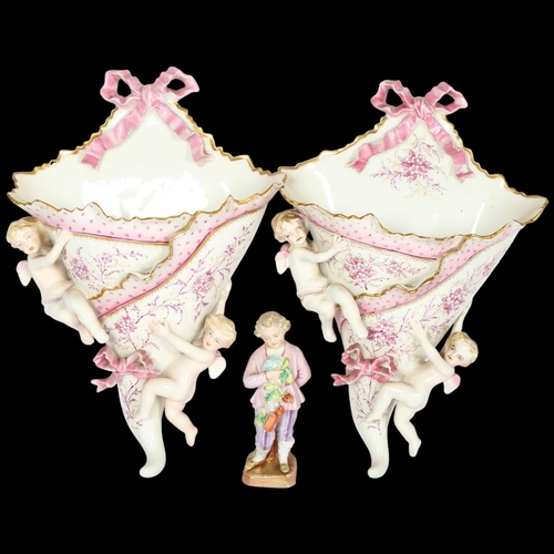 778 - A pair of Continental porcelain wall pockets with applied cherubs, and a porcelain figure, boy with ... 