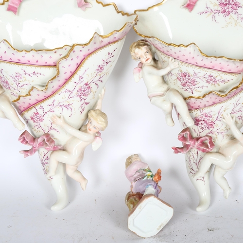 778 - A pair of Continental porcelain wall pockets with applied cherubs, and a porcelain figure, boy with ... 