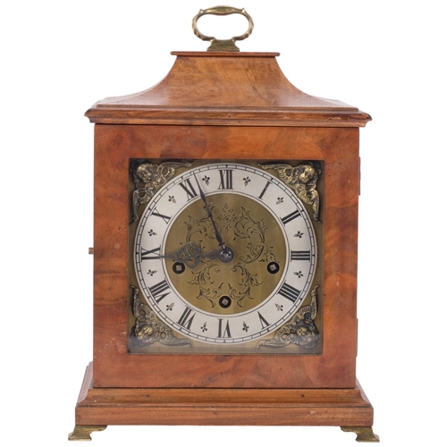 82 - A walnut-cased mantel clock with engraved dial and silver chapter ring, with 8-day gong striking mov... 