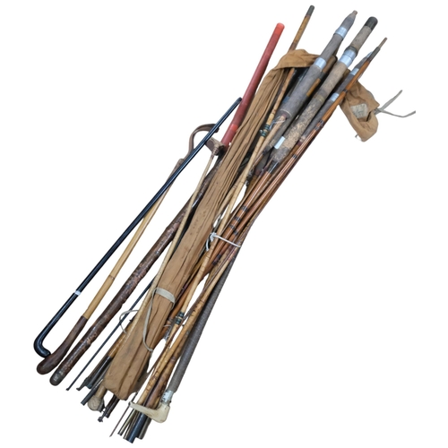 971 - A collection of Vintage bamboo and other fishing rods, walking cane etc