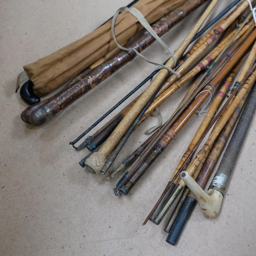 971 - A collection of Vintage bamboo and other fishing rods, walking cane etc