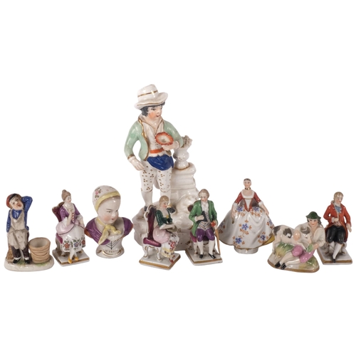 988 - A group of miniature porcelain figures, and a 19th century Staffordshire porcelain figure holding a ... 