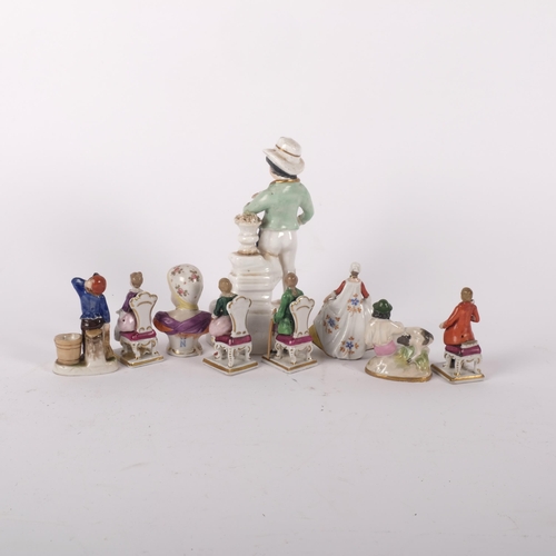 988 - A group of miniature porcelain figures, and a 19th century Staffordshire porcelain figure holding a ... 