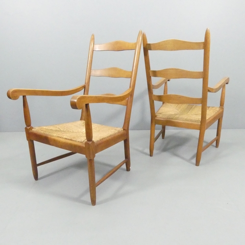 2116 - An unusual pair of Cotswold School Arts and Crafts ladderback lounge chairs in oak with rush seats.