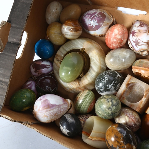 887 - A box containing a quantity of various hardstone eggs, and shells