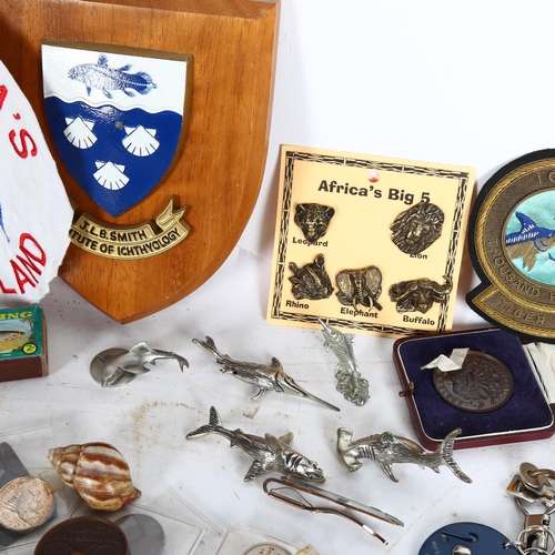 934 - A large quantity of fishing related items, including various plaques, commemorative medals and coins... 