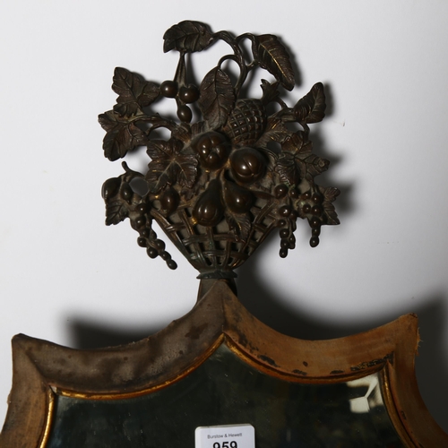 959 - A Victorian dressing table mirror, shield-shaped with bevelled glass, and cast-metal topper decorati... 