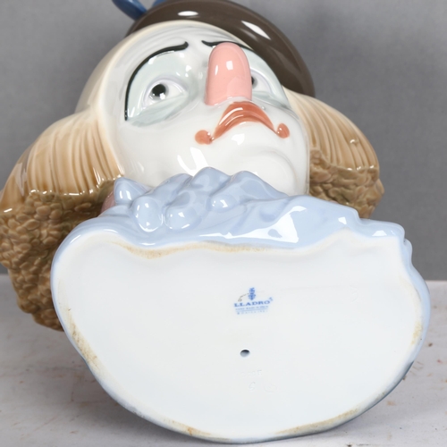 963 - A Lladro clown bust, with a sad facial expression, bust height 27cm, with associated box