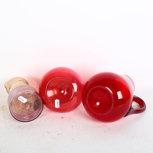 982 - A Whitefriars ruby red water jug, a cranberry decanter, and another (3)