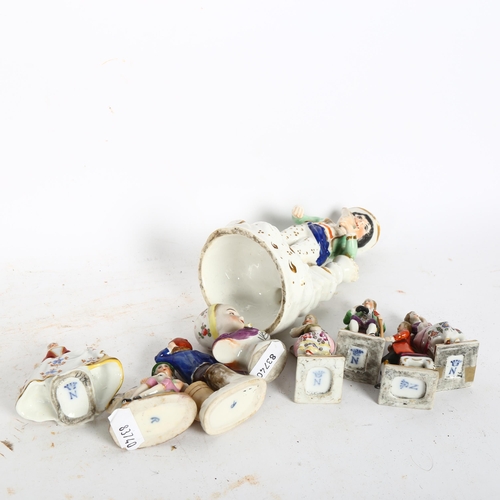 988 - A group of miniature porcelain figures, and a 19th century Staffordshire porcelain figure holding a ... 