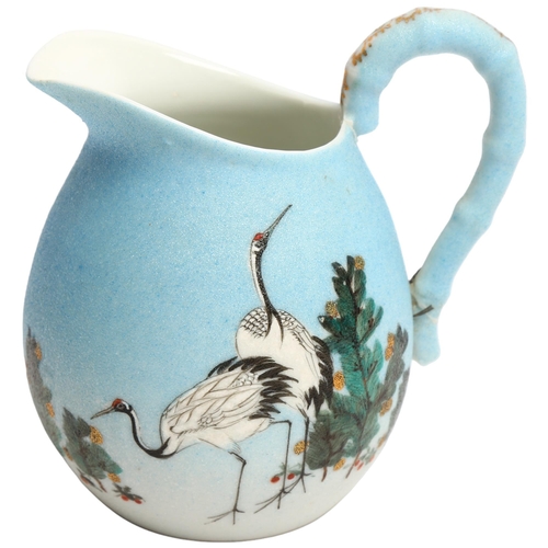 1049 - A Japanese porcelain jug with painted cranes, signed under base, height 13cm