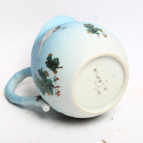 1049 - A Japanese porcelain jug with painted cranes, signed under base, height 13cm