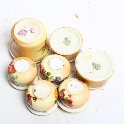 1063 - A group of miniature Royal Worcester floral decorated pill pots and covers, tallest 3cm