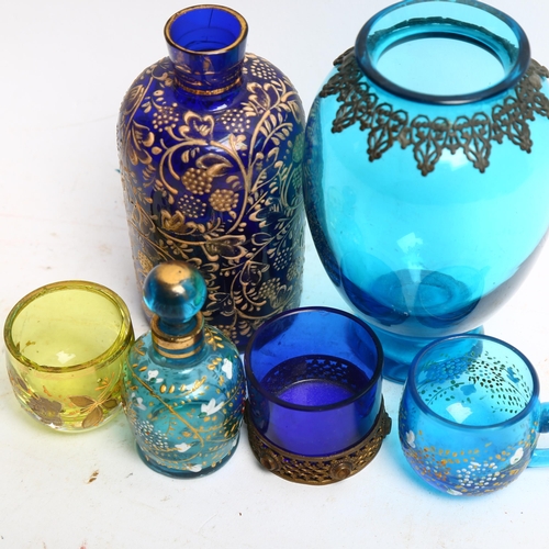 1114 - A Bristol blue and gild overlay scent bottle, a gilt and enamelled overlay scent bottle, a blue glas... 