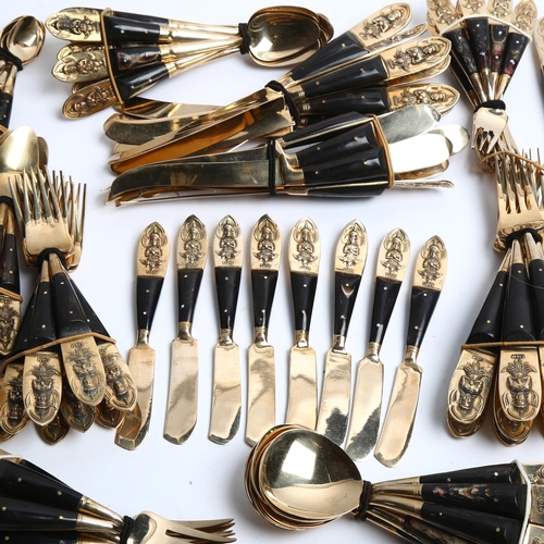 1213 - A large suite of Thai bronze and horn-handled cutlery, including serving spoons and carvers, total 1... 