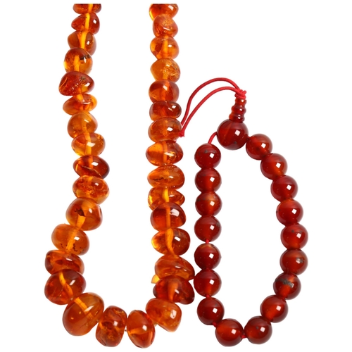 1296 - A polished amber bead necklace, and a carnelian bracelet